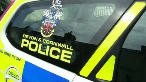 The rear window of a Devon and Cornwall Police vehicle