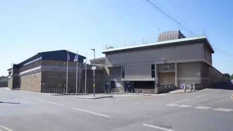 The outside of HMP Wakefield, a grey-bricked building.
