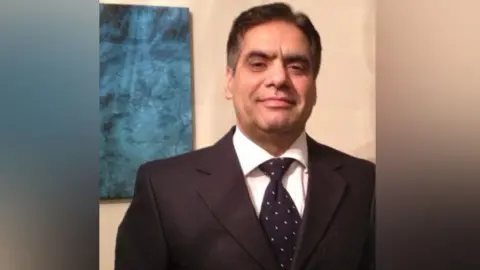 Waheed Akbar Waheed Akbar of the Workers Party of Great Britain in a suit and tie