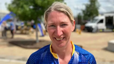 Sam Read/BBC PC Lorna Clarke with blonde hair tied back wearing a blue top