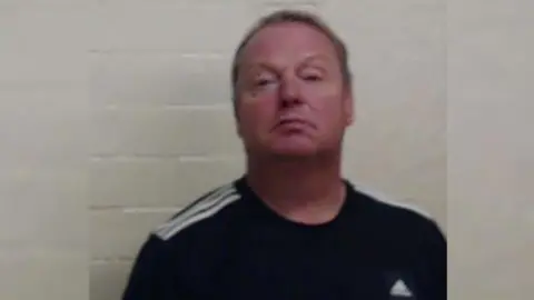 Police Scotland Berry has a dark Adidas top on. He has short hair.