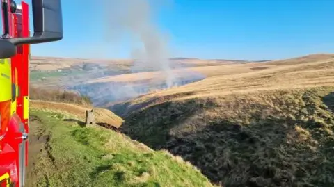 Smoke billowing from a wildfire on Marsden Moor 