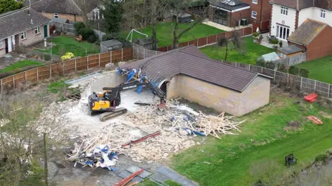 PA Media Demolison work taking place at the home of Captain Sir Tom Moore's daughter