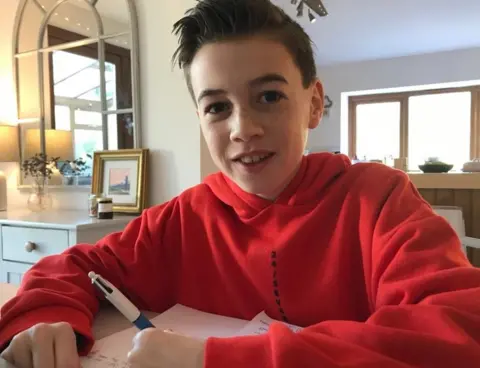 AFP Toby sitting with a book and pen