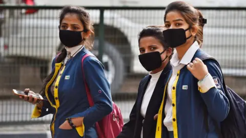 Getty Images Students wearing protective masks as a precautionary measure following multiple positive cases of Coronavirus in the country