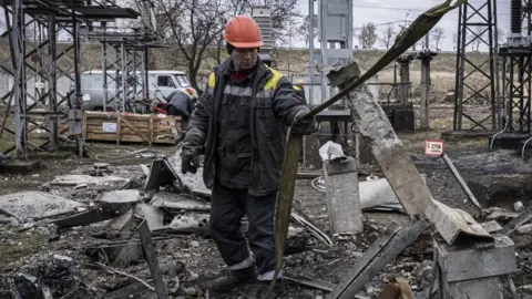 Getty Images Worker repairs infrastructure in a power station in Ukraine that was damaged by a Russian air attack.