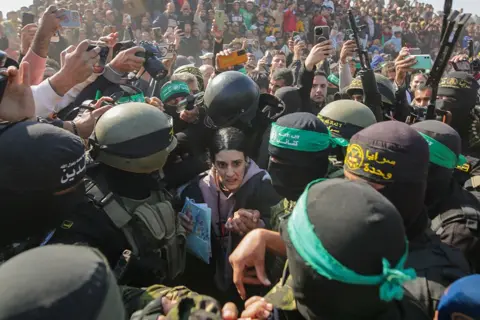 Jehad Alshrafi/AP Israeli captive Arbel Yehoud, 29, who has been held hostage by Hamas in Gaza since October 7, 2023, is escorted by Hamas and Islamic Jihad fighters as she is handed over to the Red Cross in Khan Younis, southern Gaza Strip, Thursday Jan. 30, 2025.