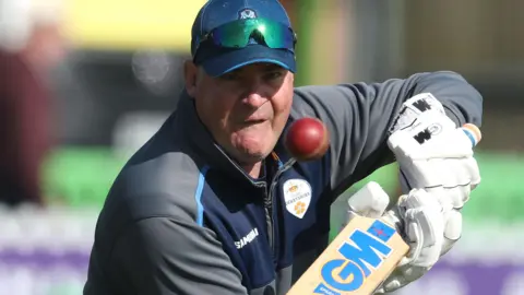 Derbyshire head of cricket Mickey Arthur gets involved with training with some batting