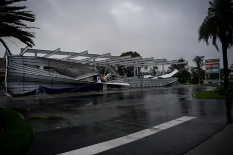 Reuters The crumbled canopy of a petrol station damaged by Hurricane Irma is seen in Bonita Springs, Florida, 10 September