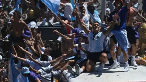 Lionel Messi's World Cup winners are greeted by thousands of fans in Buenos Aires.