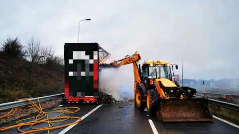 Highways England JCB helps in the clean-up