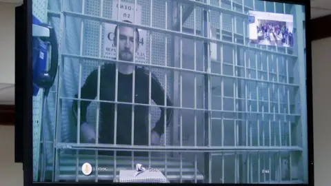 EPA Ustinov appeared in court via video link from prison