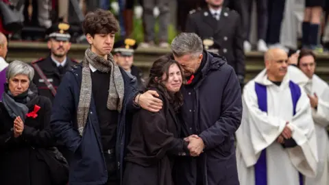Getty Images Gino Cecchettin (R), Elena Cecchetin (C) and Davide Cecchettin (L), respectively father, sister and brother of Giulia Cecchettin attend her funeral ceremony in Padua, on December 5, 2023.