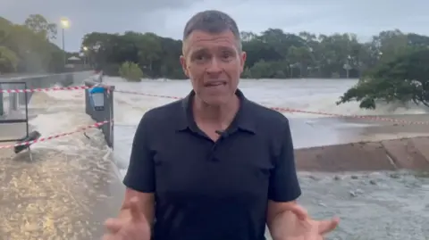 Simon Atkinson stands in front of flooded pathways