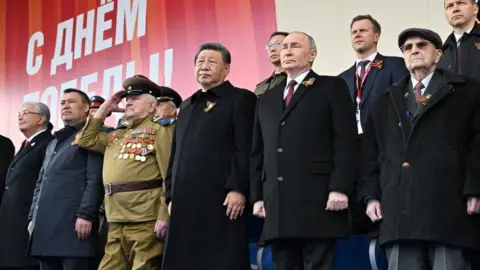 A handout photo made available by Photo host Agency RIA Novosti shows President of Russia Vladimir Putin (C-R) and President of China Xi Jinping (C-L