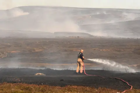 Getty Images A firefighter on Saddleworth Moor