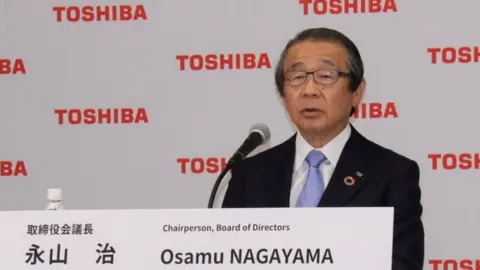 Getty Images Toshiba Board of Directors Chairperson Osamu Nagayama attends a news conference in Tokyo.