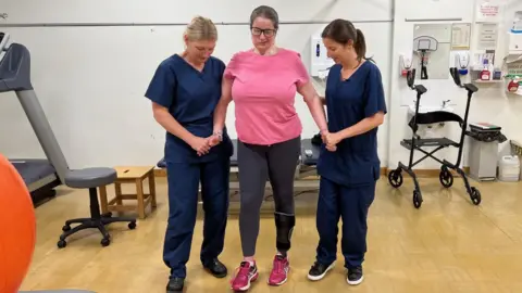 Jamie Coulson/BBC Jody Ellis surrounded by nurses at hospital in Leeds