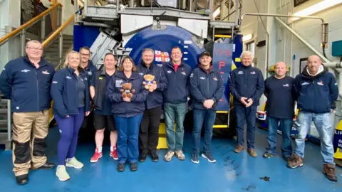 Allan Thornhill A group of people wearing navy blue lifeboat coats.