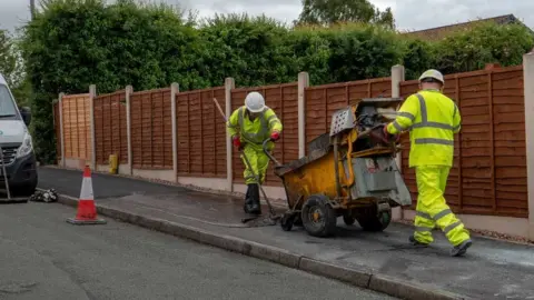 Rejuvo Workers laying asphalt