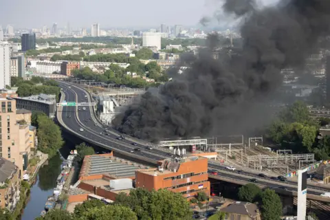 Thick black smoke billows from beside the elevated A40 Westway flyover
