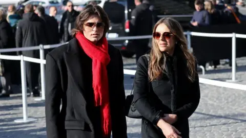 REUTERS/Yara Nardi Liz Hurley and her son Damian Hurley both dresses in black walk side by side as they arrive for the funeral
