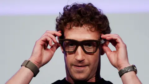 Meta CEO Mark Zuckerberg wears the Meta Ray-Ban Display glasses, as he delivers a speech presenting the new line of smart glasses, during the Meta Connect event at the company's headquarters in Menlo Park, California, U.S., September 17, 2025.