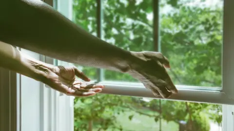 Getty Images Person opening window