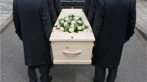 Getty Images Pallbearers carry coffin