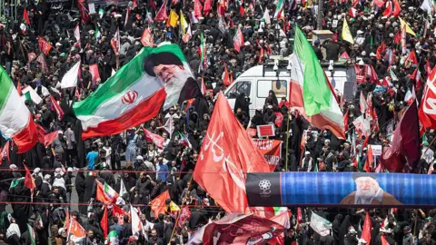 Thousands of mourners gather on a boulevard in Mashhad, northeastern Iran, ahead of the burial of Iran's late Supreme Leader Ayatollah Ali Khamenei (9 July 2026)