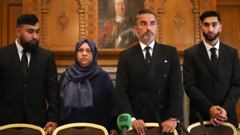 EPA Muhammad Amaad (L) and Fahir Amaaz (R) flanked mother Shameem Akhtar and solicitor Aamer Anwar