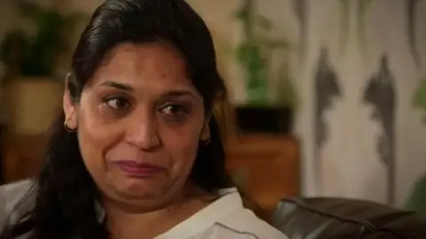 BBC Seema Misra crying on the sofa