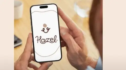 Spicy Minds A still from a video showing some text sharing the spicyminds.org website. On the left, there is an image of a person holding a phone with the Hazel App open on it.