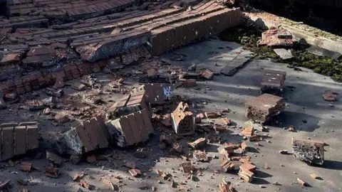 Broken bricks on a pavement in Reading in February 2022