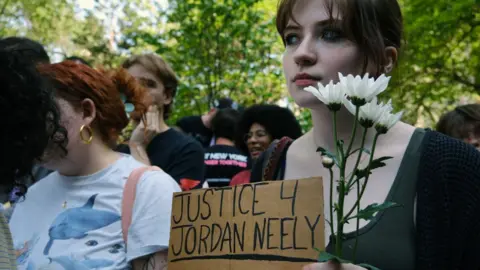 Getty Images People attend a vigil at City Hall Park for Jordan Neely, who was fatally choked on a subway by a fellow passenger ten days ago, on May 11, 2023 in New York City