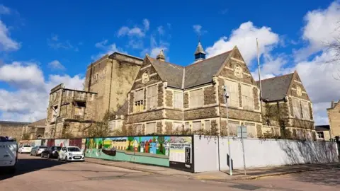 Swindon Borough Council Imposing Mechanics' Institute building surrounded by fencing