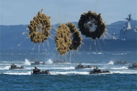 Lee Jin-man / Reuters South Korean Marines' amphibious assault vehicles sail to shore for landing in Pohang, South Korea