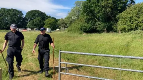 Carla Fowler/BBC Two police officers at search site in field