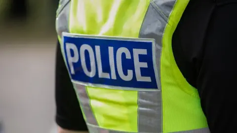 Getty Images Back of police officer