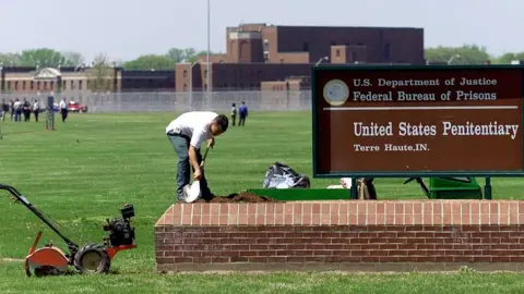 Getty Images A worker cleans a sign at the death row in Terre Haute, Indiana