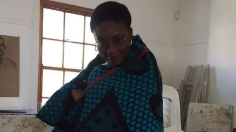 Penny Dale Mayeni putting traditional Basotho blanket