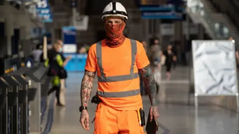 Getty Images Construction worker wearing a face mask