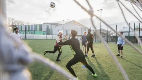 Getty Images A group of young men playing football on an artificial pitch