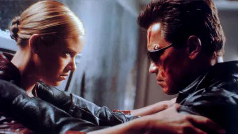 Moviestore Collection/Shutterstock Arnold Schwarzenegger with Kristanna Loken in Terminator 3: Rise of the Machines