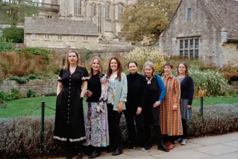 Leia Morrison The Garden, Library, and Museum (GLAM) team line up for a portrait in Christ Church Memorial Gardens.
