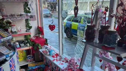 Aniseed Rock The front window has a big circular hole in it. There are sweets and teddies also pictured. 