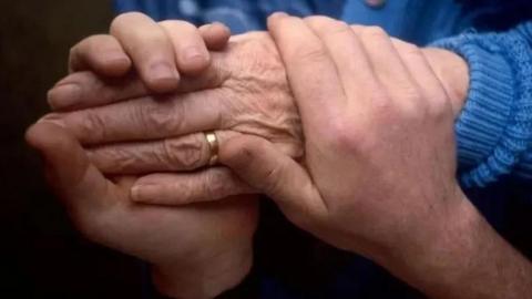 A close-up of someone holding someone else's hands