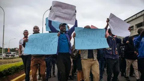 AFP members of the Kenya Aviation Workers Union (KAWU) gather outside the Jomo Kenyatta International Airport (JKIA) over plans to sell Adani Airport Holdings Ltd., in Nairobi, Kenya, Monday, September 2, 2024. 