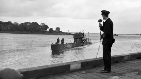 Surrender of German U-Boat. BBC Commentator Lt. Commander Harry McMullan, reporting on the surrender of German U-boats in Northern Ireland.