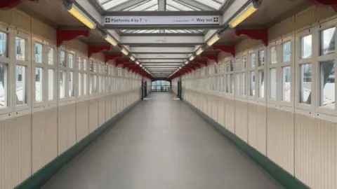 EMR A footbridge that at Nottingham railway station with signs showing directions to different platforms